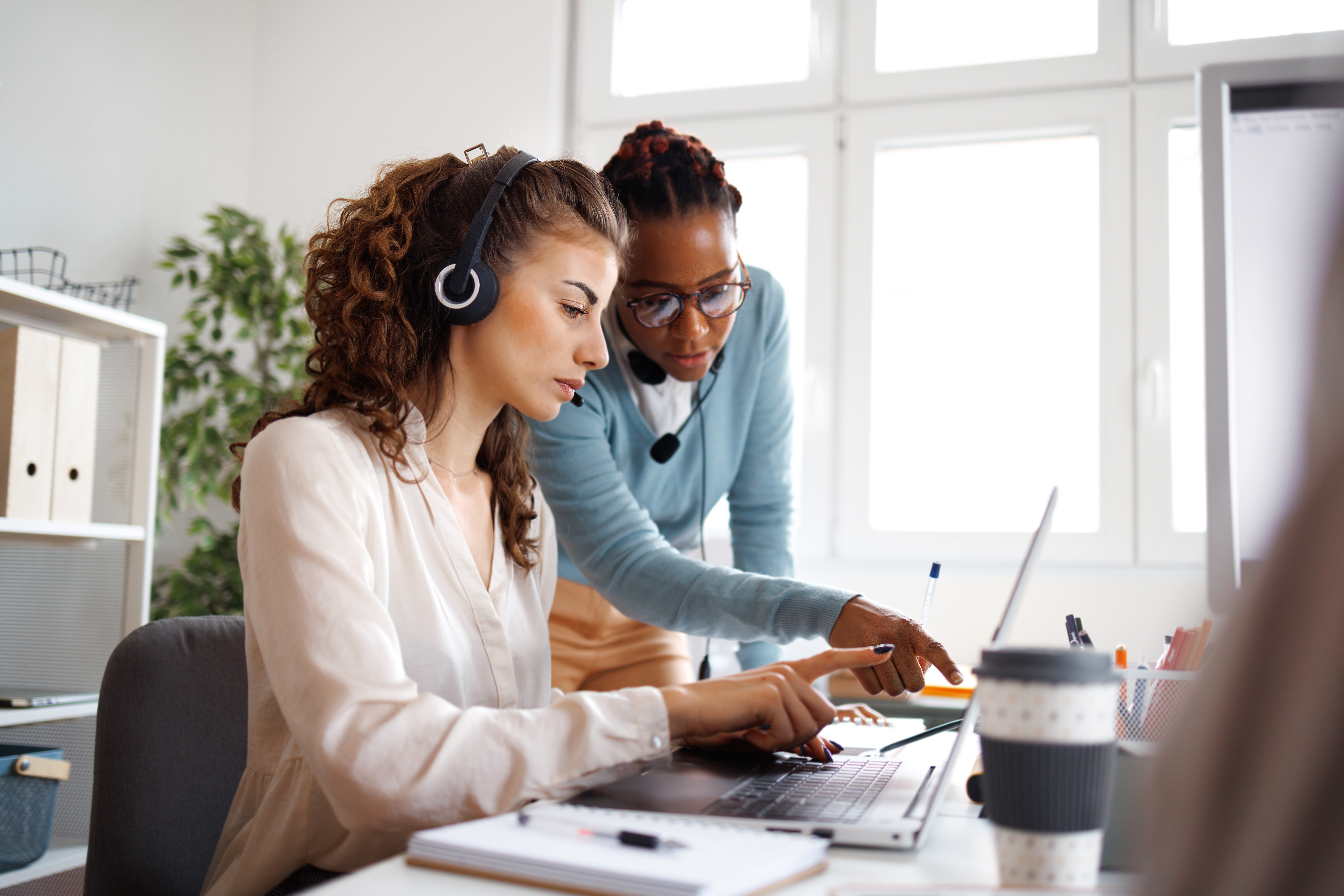 Female real estate agents working together in small offfice