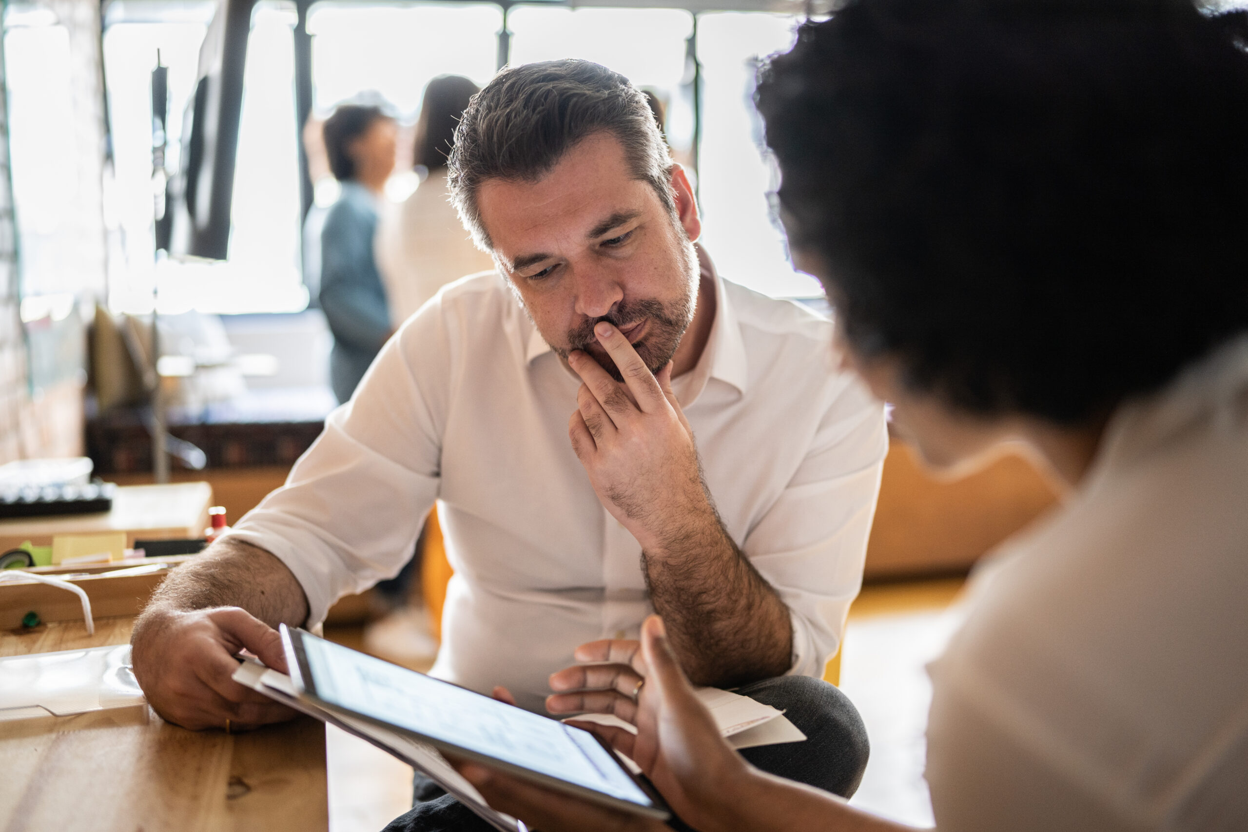 Real estate agents looking at tablet